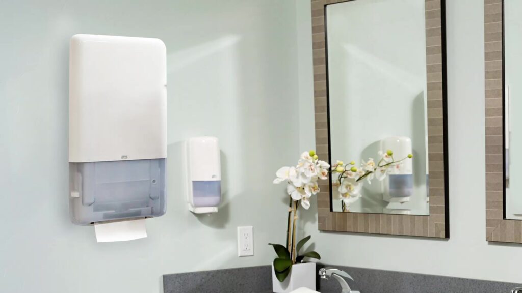 Bay West Caribbean dispensing systems for bathrooms, featuring Tork, Purell, and Kutol dispensers